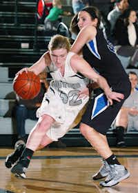 Guyer senior forward Katy Davis drives past Trophy Club Byron Nelson forward Madison Edwards, right, on Friday at Wildcat Gymnasium.DRC/David Minton