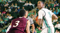 North Texas forward Justin Patton, right, looks to pass around Louisiana-Monroe guard Marcelis Hansberry on Saturday at the Super Pit.DRC file photo