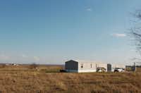 Trailer homes owned by Canyon Falls Land Partners LP sit on a hill overlooking open fields of prairie on Cleveland Gibbs Road. The 1,240-acre Canyon Falls development is planned for the area between Argyle, Flower Mound and Northlake.DRC - David Minton