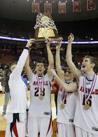 Argyle senior Clarke Overlander, second from left, holds the Class 3A trophy as he celebrates with teammates March 10 in Austin.DMN file photo