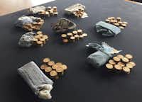 The 913 gold coins which were found in a piano, are displayed at Ludlow Museum in Ludlow, England Thursday April 20, 2017, where they are being kept under lock and key. As a mystery surrounds the identity of the rightful heirs to a treasure trove of gold coins. British officials say they have been unable to trace the rightful heirs to a trove of gold coins worth a "life-changing" amount of money. The school that owns the piano and the tuner who found the gold are now in line for a windfall after a coroner investigating the find declared it treasure. (Richard Vernalls/PA via AP)AP