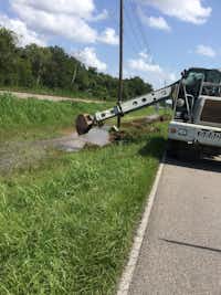 A city of Denton crew helps clean a drainage ditch in Lake Jackson. The work is part of emergency repairs to Lake Jackson's sewer system, which was overwhelmed with storm water from Harvey.City of Denton