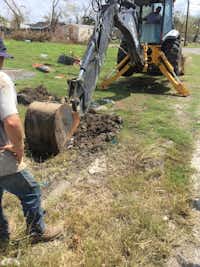 A Denton public works crew digs to reach a broken water main in Refugio. Debris from Hurricane Harvey is still noticeable in the area.City of Denton