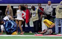 ARLINGTON, TX - DECEMBER 29: Sam Darnold #14 of the USC Trojans is shoved out of bounds on a late hit by the Ohio State Buckeyes in the fourth quarter during the Goodyear Cotton Bowl Classic at AT&T Stadium on December 29, 2017 in Arlington, Texas. (Photo by Tom Pennington/Getty Images)Getty Images