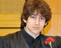 In this undated photo provided by Robin Young, Dzhokhar A. Tsarnaev, poses for a photo after graduating from Cambridge Rindge and Latin High School. Tsarnaev has been identified as the surviving suspect in the marathon bombings. Two suspects in the Boston Marathon bombing killed an MIT police officer, injured a transit officer in a firefight and threw explosive devices at police during a getaway attempt in a long night of violence that left one of them dead and another still at large Friday, April 19, 2013.Robin Young - AP