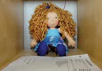 A completed doll awaits shipping to its new home in a bin at Dragonfly’s Hollow on Oakland Street last week.Al Key/DRC