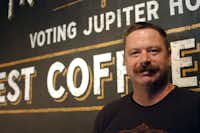 Sean Starr stands in front of a mural he painted for Jupiter House Coffee. Starr runs Starr Studios, a branding, design and sign painting studio in Denton.DRC/David Minton