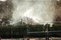 Firefighters hose down the smoldering remains after a gas explosion destroyed a building on E Main St in Lewisville Friday afternoon causing a 3-alarm fire, Friday, January 11, 2013, in Lewisville, TX.David Minton - DRC