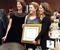 Janet Shelton, left, Denton Public School Foundation vice president of development, Vicki Sargent and Karen Goff, foundation president, stand with Sargent after she is thanked for her service at the foundation’s Groundhog Day Gala on Saturday.David Minton - DRC
