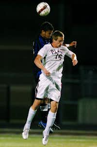 Guyer junior midfielder McKenna Cook (16) and Plano senior forward Lukas Teese (16) go up for a header, Wednesday, April 4, 2012, at Tommy Briggs Cougar Stadium in The Colony, Texas.David Minton