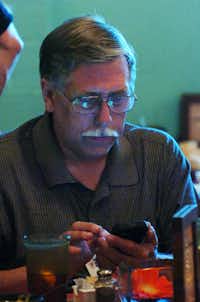 Denton County Sheriff Benny Parkey check his cell phone soon after the publication of early voting results during an election night event at El Guapo's resturant, Tuesday, May 29, 2012, in Denton, TX.David Minton