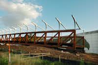 The various parts of the pedestrian bridge which will link the parking lot at Fouts Field with Apogee Stadium liw waiting to be combined later this week, Sunday, July 22, 2012, in Denton, TX.David Minton