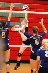 Argyle's Maddie Moseley (8) drives a hit as Denton's Hannah Altman (5) and Kallie Smith (6) try to block, Tuesday, August 21, 2012, in Argyle, TX.David Minton