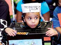 Julius Barron illustrates his phrase “rectangular prism” by wearing amicrowave costume during the Vocabulary Parade at Rivera Elementary School on Wednesday.Al Key