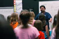 The Blanton Elementary School Squire Choir, directed by Victor Lozada Jr., practices Tuesday for its performance today in the annual Dallas Police Memorial DayDavid Minton - DRC