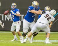 Tulsa quarterback Dane Evans, left, looks to pass against Central Michigan in the Miami Beach Bowl on Dec. 19 in Miami.Erik Campos
