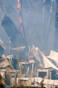 Firefighters work to finish extinguishing a fire that started in a workshop on Odneal Rd, Tuesday, July 23, 2013, in Krum, TX.David Minton - DRC