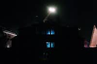 The beams from flashlights of firefighters inside shine out the back windows of a home on Blanco Dr in the Lantana community after a fire late Wednesday night, Wednesday, May 29, 2013.David Minton - DRC