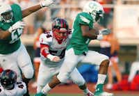 Lake Dallas sophomore running back Courtenay Holder (14) charges through a gap in the Frisco Centennial defense, Friday, September 6, 2013, at Falcon Stadium in Corinth, TX.David Minton