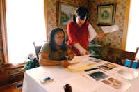Joy Miller-Davis and her family look over photos and letters from ancestors in the dining room of the Bayless-Selby House Museum. Joy is a descendant of the first black doctor in Denton who practiced in Quakertown in the early 1900s, Wednesday, July 17, 2013, in Denton, TX.David Minton - DRC