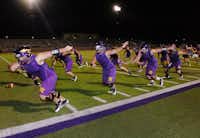 Sanger offensive linemen go through drills during the first practice of the season just after midnight Monday August 5, 2013, in Sanger.Al Key - DRC
