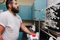 Water Operator Jason Lucero performs a routine test on water from Lewisville Lake being disinfected at the Upper Trinity Regional Water District facility Tuesday in Lewisville.Al Key - DRC