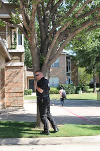 Deputy Corry Blount with the Denton County Sheriff's Office stands by as part of a group serving warrants with investigators from District Attorney Paul Johnson's office Friday morning across the Dallas-Fort Worth metroplex.Megan Gray - DRC