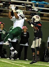 Lake Dallas’ Bryce Williams, left, catches a pass in front of Wichita Falls’ Orryn Clark during the second quarter Thursday at Memorial Stadium in Wichita Falls.Patrick Johnston