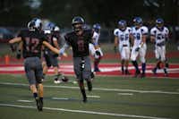 Argyle's Cole Hedlund congratulates Hunter Treadwell (8) after he scored a touchdown during a high school football game between Argyle and Fort Worth Nolan at Argyle's Eagle Stadium in Argyle, Friday, Sept. 6, 2013.Garett Fisbeck