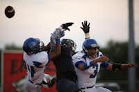 A pass to Argyle's Ian Sadler (5) is blocked by Fort Worth Nolan's Frank Colin (24) and Jose Torres (3) during a high school football game between Argyle and Fort Worth Nolan at Argyle's Eagle Stadium in Argyle, Friday, Sept. 6, 2013.Garett Fisbeck