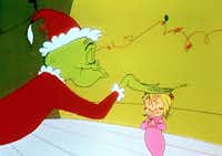 The Grinch pats the head of Cindy Lou in the 1966 animated version of How the Grinch Stole Christmas. It’s one of the TV specials collected in Hats Off to Dr. Seuss: Collector’s Edition.Warner Bros.