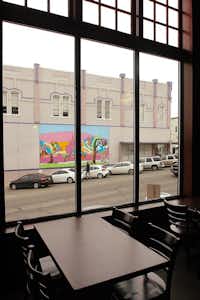 Tall windows by the tables look out over Locust Street at Cafe Herrera in Denton.Al Key - DRC