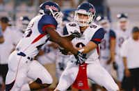 Ryan senior quarterback Mitchell Bridges (9) hands off to junior running back Maurice Gordon (28) against Corsicana, Friday, August 30, 2013, at Tiger Stadium in Corsicana.David Minton