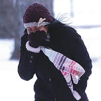 Kayla Joseph, a University of North Texas freshman, crosses the campus in Tuesday’s freezing temperatures and gusting winds.